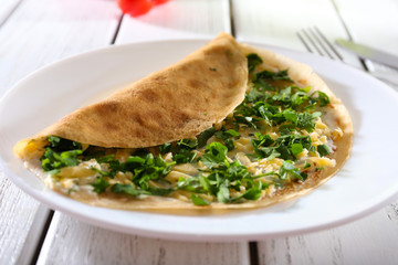 Pancakes with cream, cheese and greens in plate