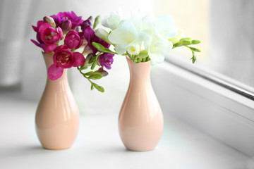 Beautiful spring flowers on windowsill background