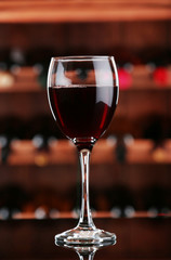 Glass of red wine on bar background