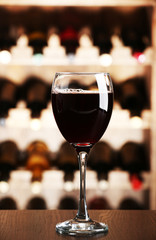 Glass of red wine on bar background
