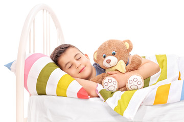 Cute little kid sleeping with a teddy bear