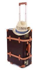 Suitcase and straw hat isolated on white