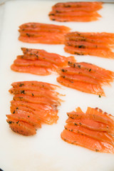 Salmon fillet slices with fresh herbs.
