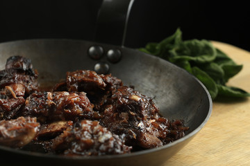 Pork ribs with honey-soy sauce in the frying pan