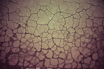 Crack dry soil ground background in vintage color