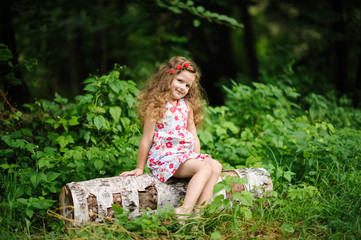 Little pretty girl in the green garden