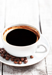 Coffee Espresso. Coffee cup with roasted coffee beans over white