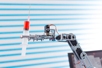 medical syringe in robot arm