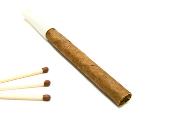Cigarillo and few matches on white