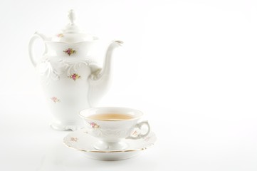 Old-style retro jug with tea on white background