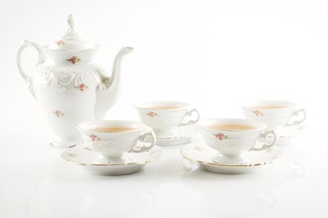 Vintage party kettle with four cups of tea
