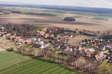 aerial view of spring time village harvest fields landscape