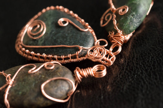 Some wire wrapped pendants against a dark background