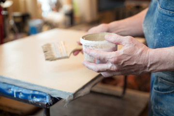 An artist priming canvas