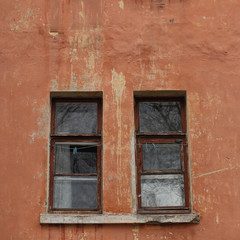 Fototapeta na wymiar Windows on the wall of an old house