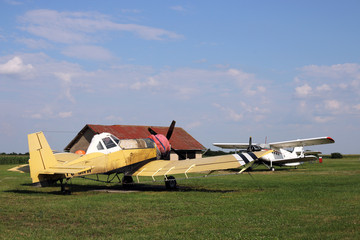 crop duster airplanes on airfield
