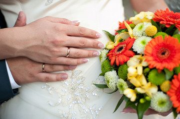 Obraz na płótnie Canvas groom embraces the bride, the bride holds a wedding bouquet