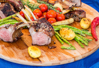 Fresh grilled beef meat on wood plate with vegetables