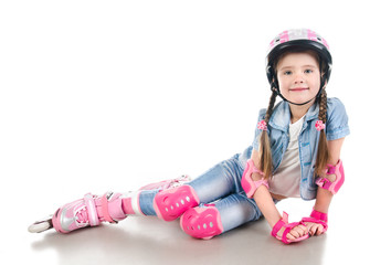 Cute smiling little girl in pink roller skates