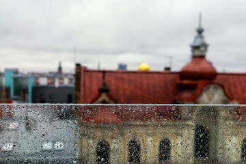 Roofs and spiers of the city behind a glass partition in the rai