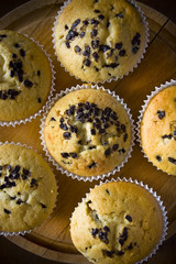 Sweet muffins on a wooden board in daylight