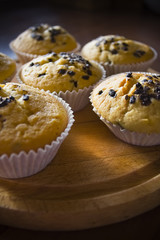 Sweet muffins on a wooden board in daylight