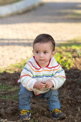 Child playing with soil in a park