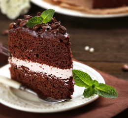 Delicious chocolate cake on table close-up