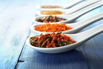 Different kinds of spices in ceramics spoons, close-up,