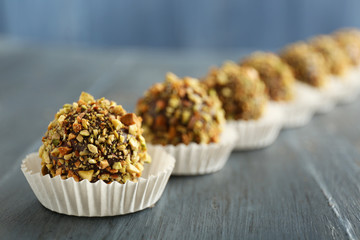 Tasty homemade pistachio candies on wooden table