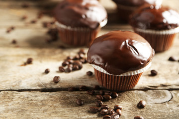 Tasty homemade chocolate muffins on wooden table