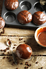 Tasty homemade chocolate muffins on wooden table
