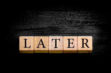 Word LATER isolated on black background with copy space