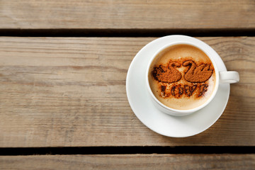 Cup of coffee on old wooden table