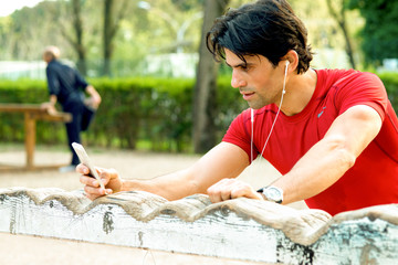 Runner reviewing his sport performance on mobile phone