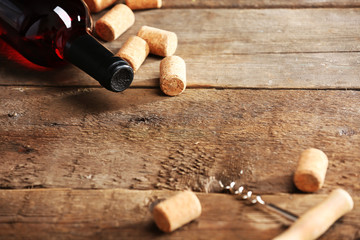 Glass bottle of wine with corks and corkscrew