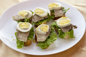 Sandwiches with boiled egg and tongue.