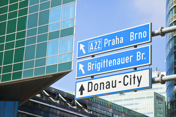 Obraz premium Donau City roadsign on blue background (Wien - Austria)