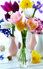 Beautiful bouquets of spring flowers on windowsill background