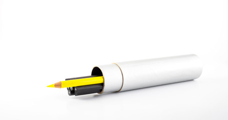 Yellow pencil outstanding from black pencil in round pencil box