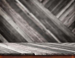 Empty wood table top with blur diagonal wood wall.