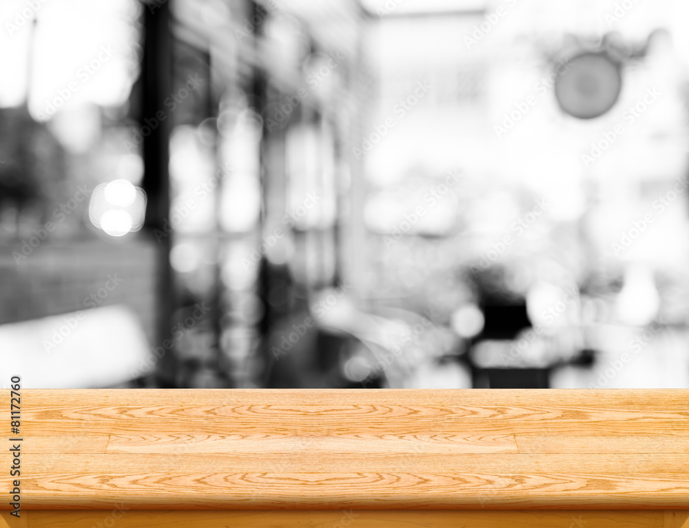 Poster empty wood table top with coffee shop blur with bokeh background