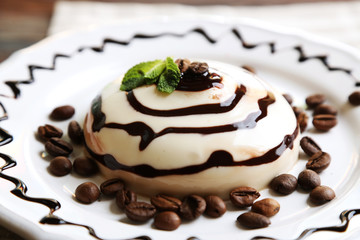 Tasty panna cotta dessert on plate, close up