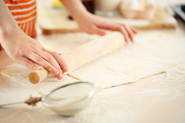 Obraz na płótnie Canvas Making croissant cookies. Rolling dough.