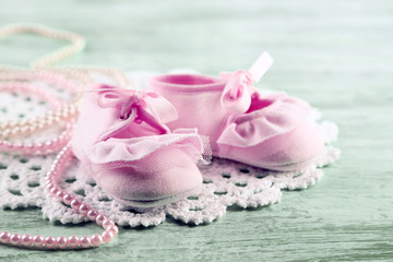 Cute toddler shoes on wooden background