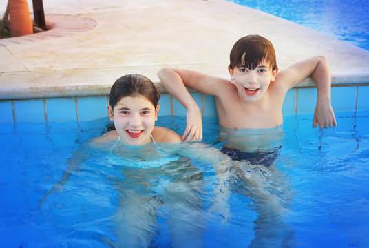 Siglings Boy And Girl Play In Open Air Swimming Pool At The Egyp