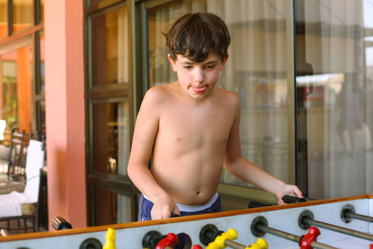 Handsome Preteen Boy Play Table Soccer In Beach Resort Hotel Rec