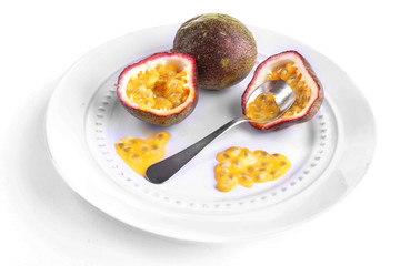 Passion fruit on plate isolated on white