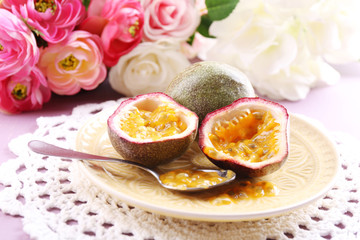 Passion fruit on plate on color wooden background