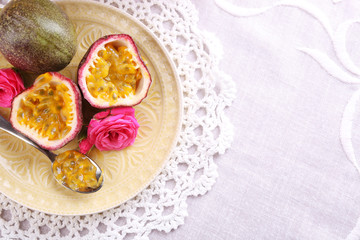 Passion fruit on plate on color wooden background